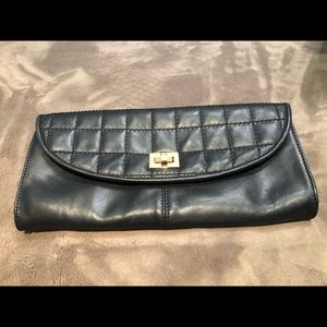 Black, leather clutch with animal print interior.